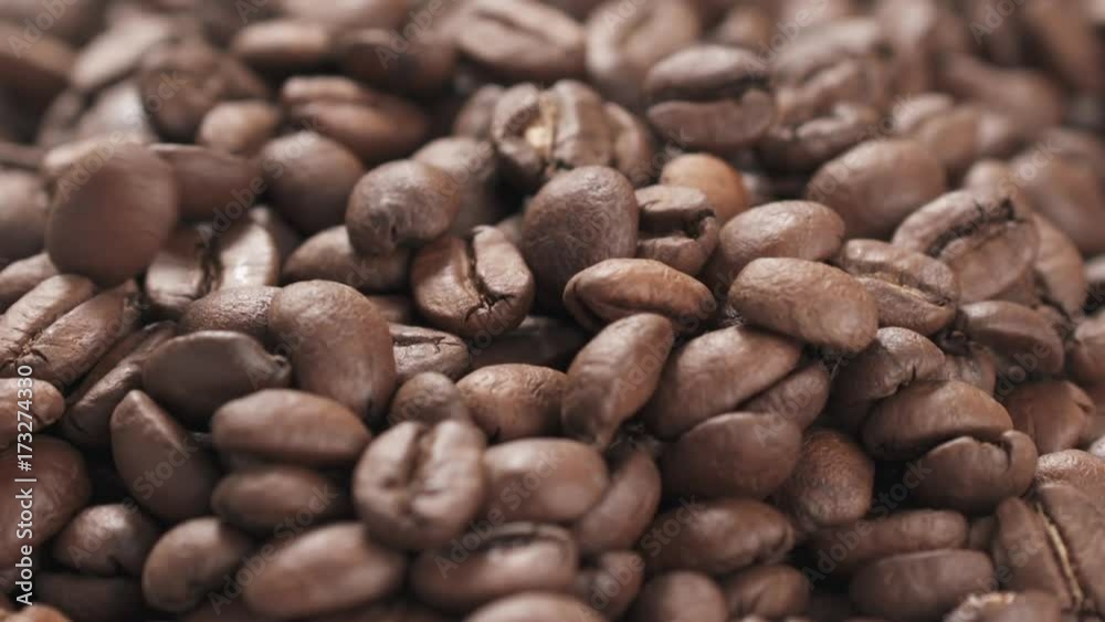 Slow motion closeup coffee beans falling into bowl Slow motion closeup coffee beans falling into bowl