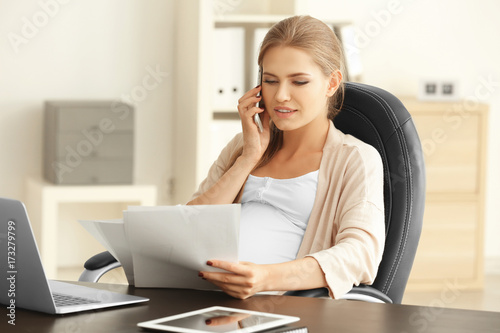 Young pregnant woman working in home office © Africa Studio