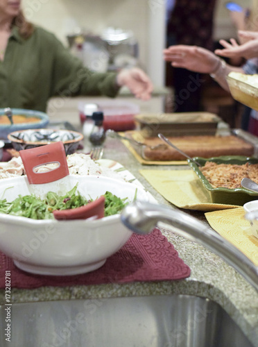 People serving themselves Thanksgiving dinner