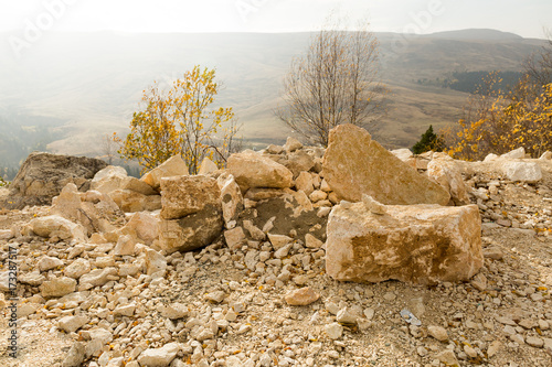 trekking, sport life, health concept. on the edge of mountain there are lots of lumps and small stones of creamy white colour, they are covered all surface of mountain sides