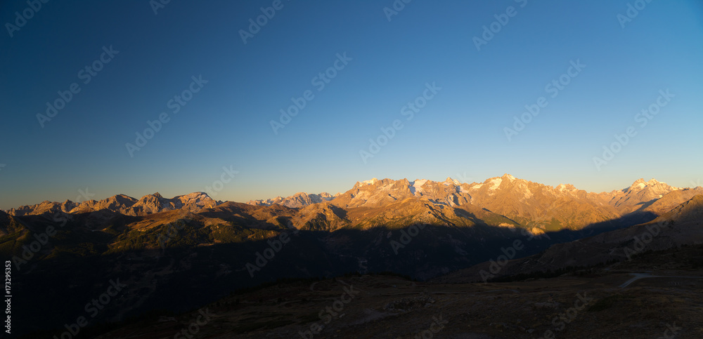 The majestic peaks of the Massif des Ecrins (4101 m) national park with the glaciers, in France, at sunrise. Clear sky, autumn colors.