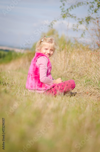 child sitting in grass