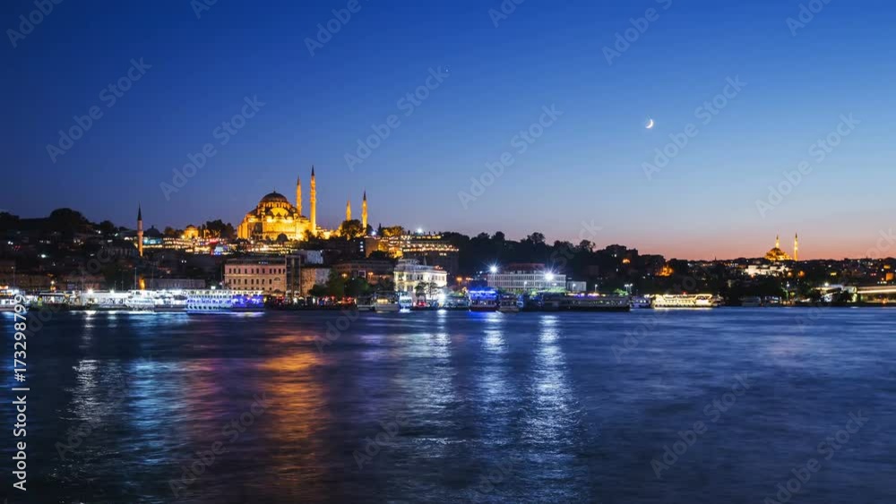 Zoom out Timelapse view of Istanbul cityscape with Suleymaniye mosque with tourist ships floating at Bosphorus at night Zoom out Timelapse view of Istanbul cityscape with Suleymaniye mosque with tourist ships floating at Bosphorus at night