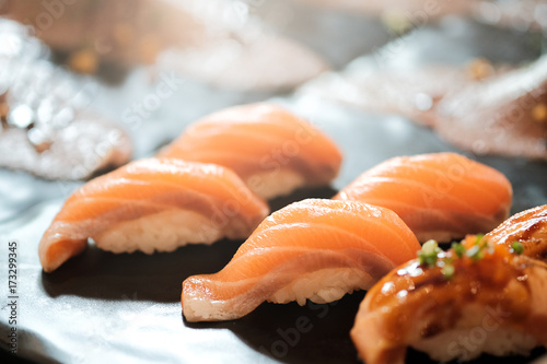 Salmon sushi over black background