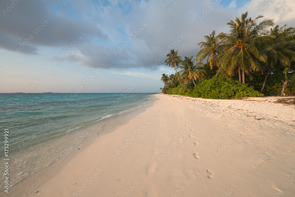Tropical beach with footprints in the sand