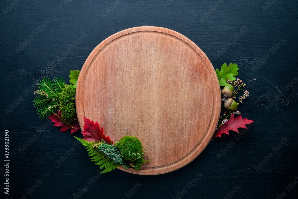 Autumn motif, forest grasses and forest mushrooms on a wooden background. Top view. Free space for text. Autumn motif, forest grasses and forest mushrooms on a wooden background. Top view. Free space for text.