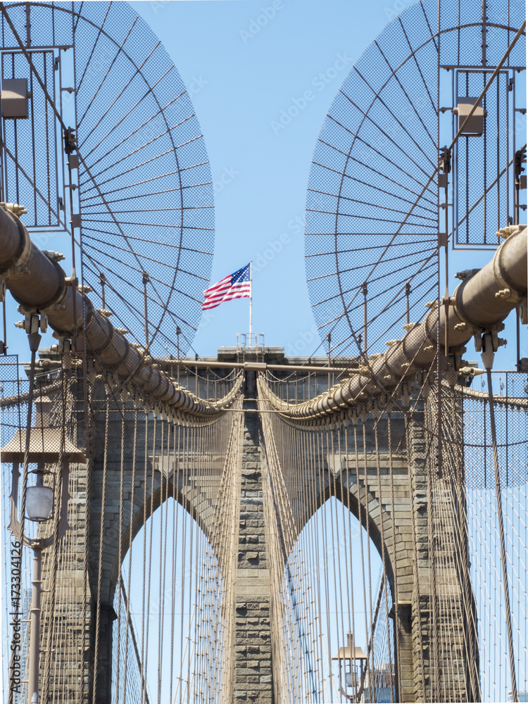 Obraz premium Brooklyn Bridge Tower with USA flag - Brooklyn, New York, NY, United States of America, USA