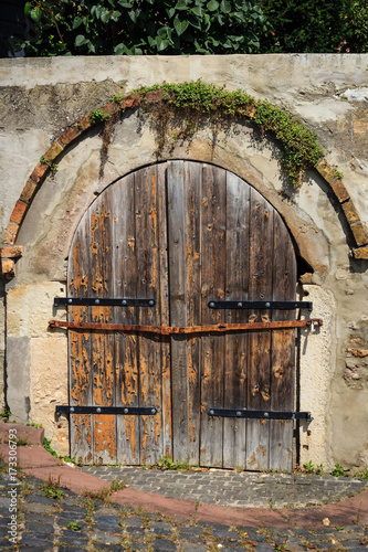 Old wooden gate in a wall