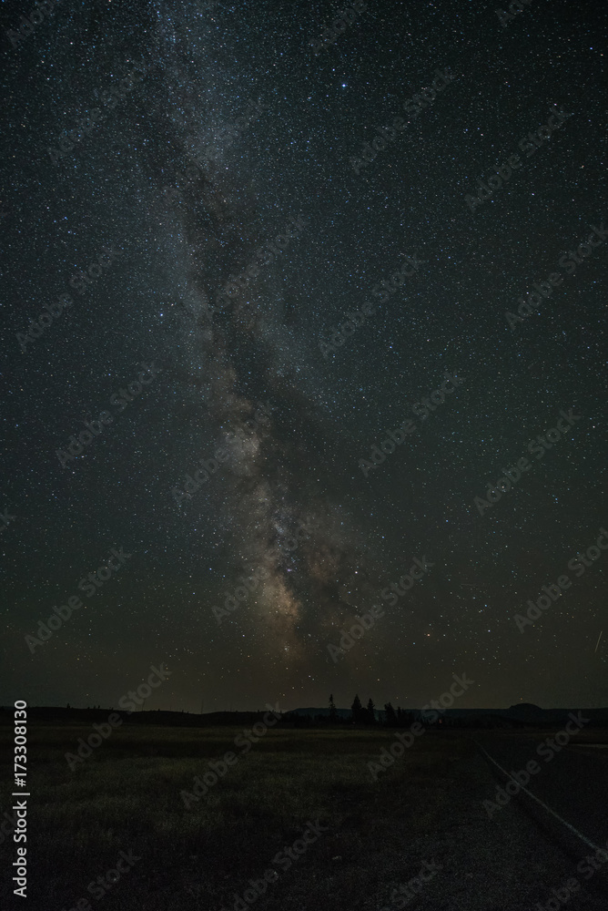 The Milky Way band with the galactic core setting on the horizon of Yellowstone National Park.