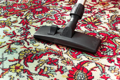Принти на полотні Cleaning dirty old carpet with a vacuum cleaner universal nozzle