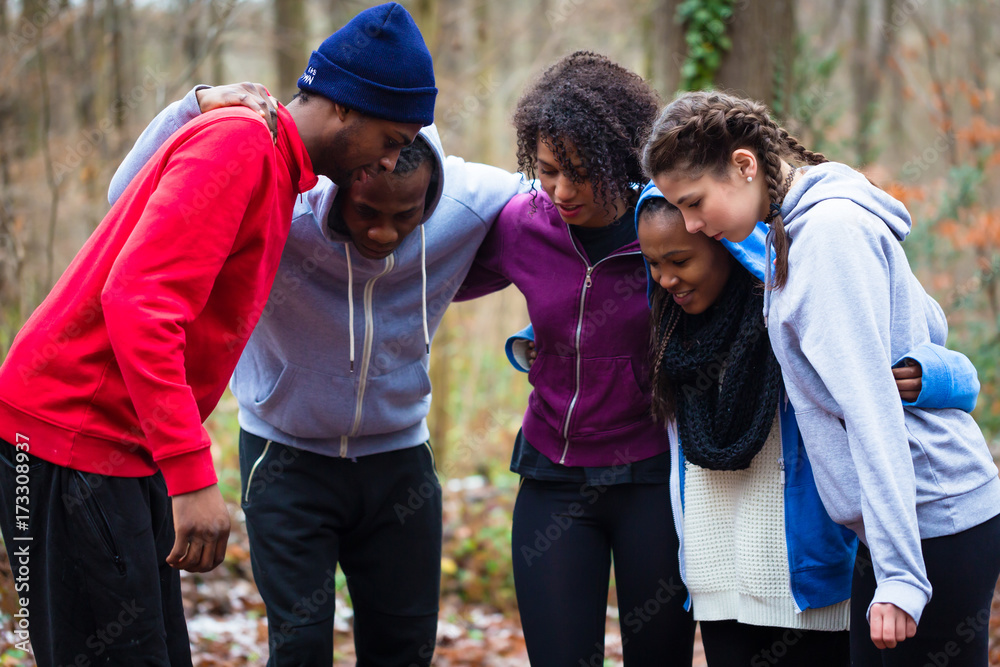 United and motivated young team preparing for an outdoors workout session United and motivated young team preparing for an outdoors workout session