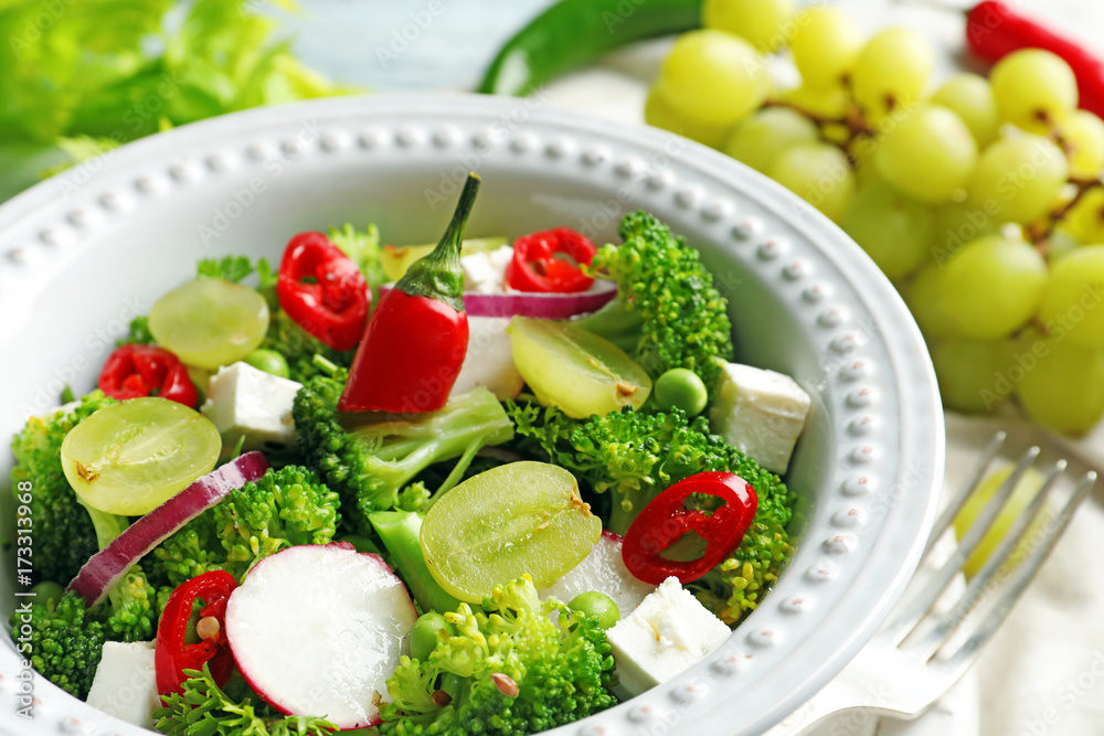 Dish with broccoli salad on table, closeup Dish with broccoli salad on table, closeup