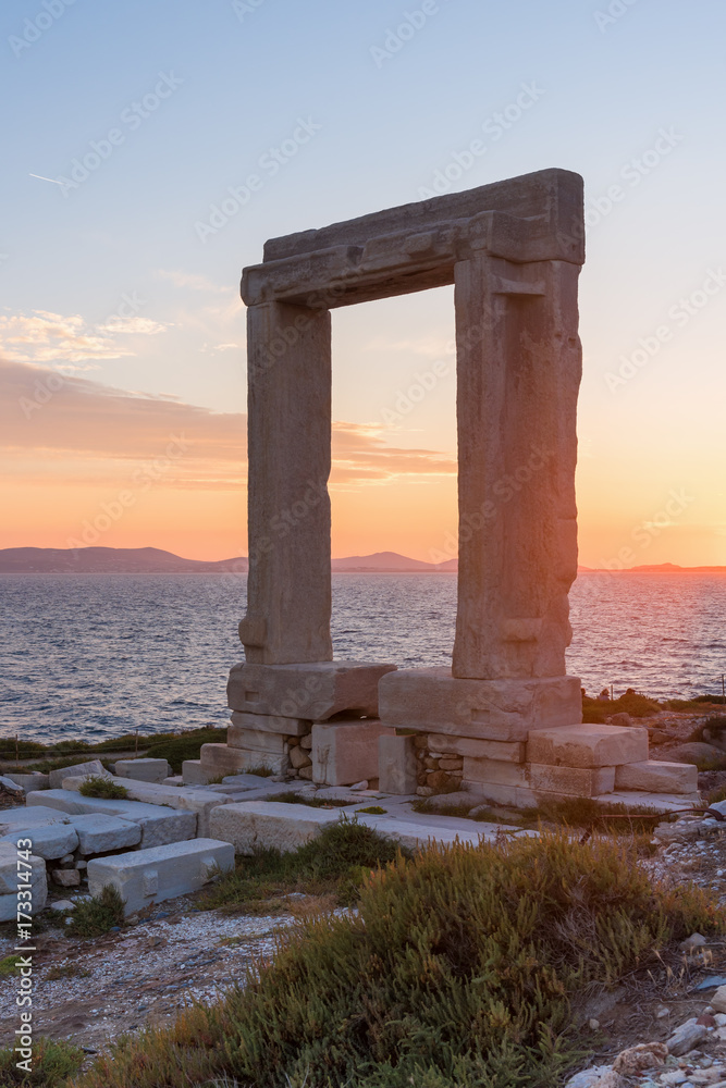 The Portara, one of Naxos island most famous landmarks with overlooking the sea. Cyclades Islands, Greece. 