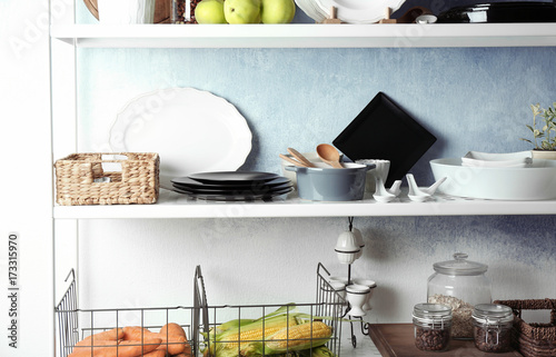 Storage stand with kitchenware indoors