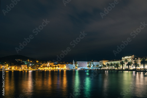 Croatia. Evening panorama of the embankment of Split, with a multicolored reflection in the sea water