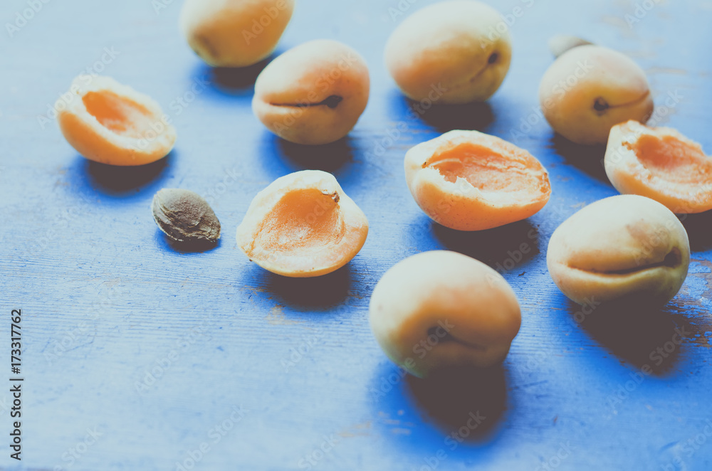 Apricots on blue table, natural background