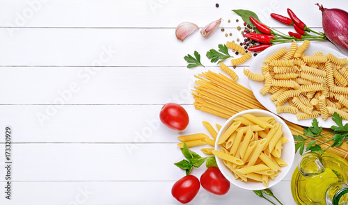 Pasta and ingredients: spaghetti, pens and fusilli, tomatoes, chili peppers, garlic, parsley, basil and extra virgin olive oil