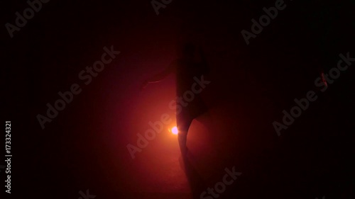 Silhouette dancing on red background