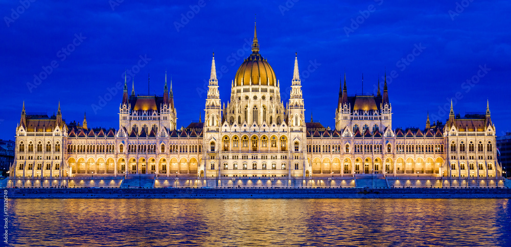 Night view of the Hungarian Parliament and the Danube River in Budapest, Hungary
