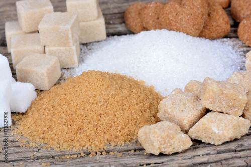 Various types of sugar on wooden table