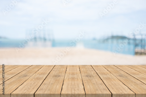 Empty wooden table in front with blurred background at the beach,space for montage you products