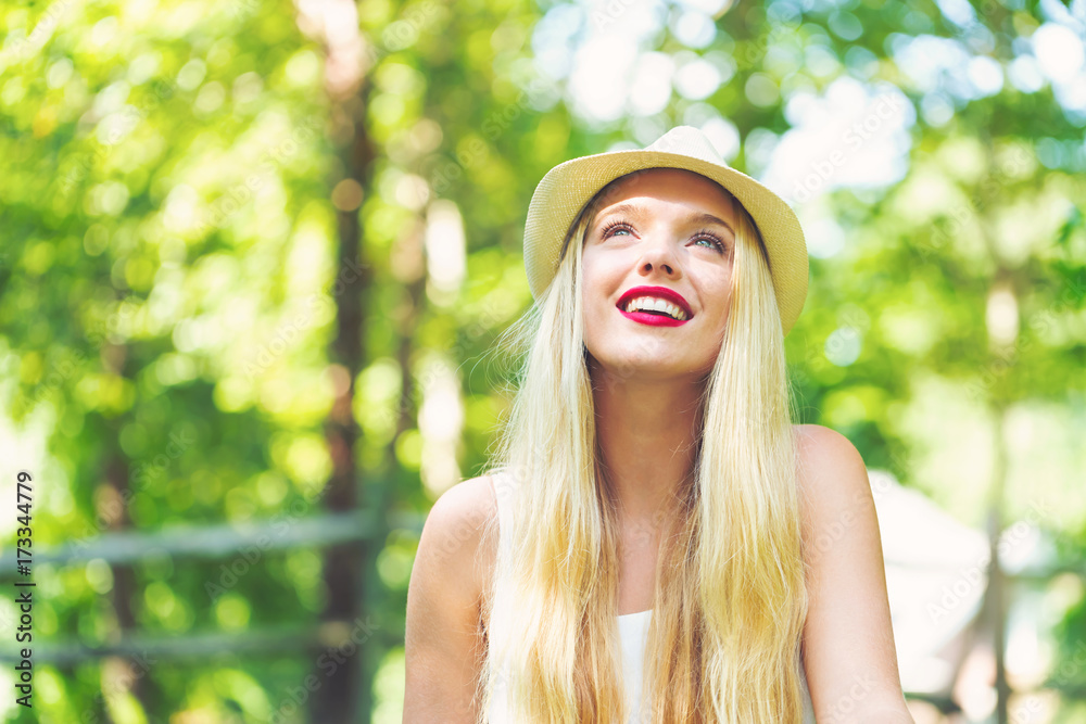 Naklejka premium Young woman sitting outside on a beautiful summer day