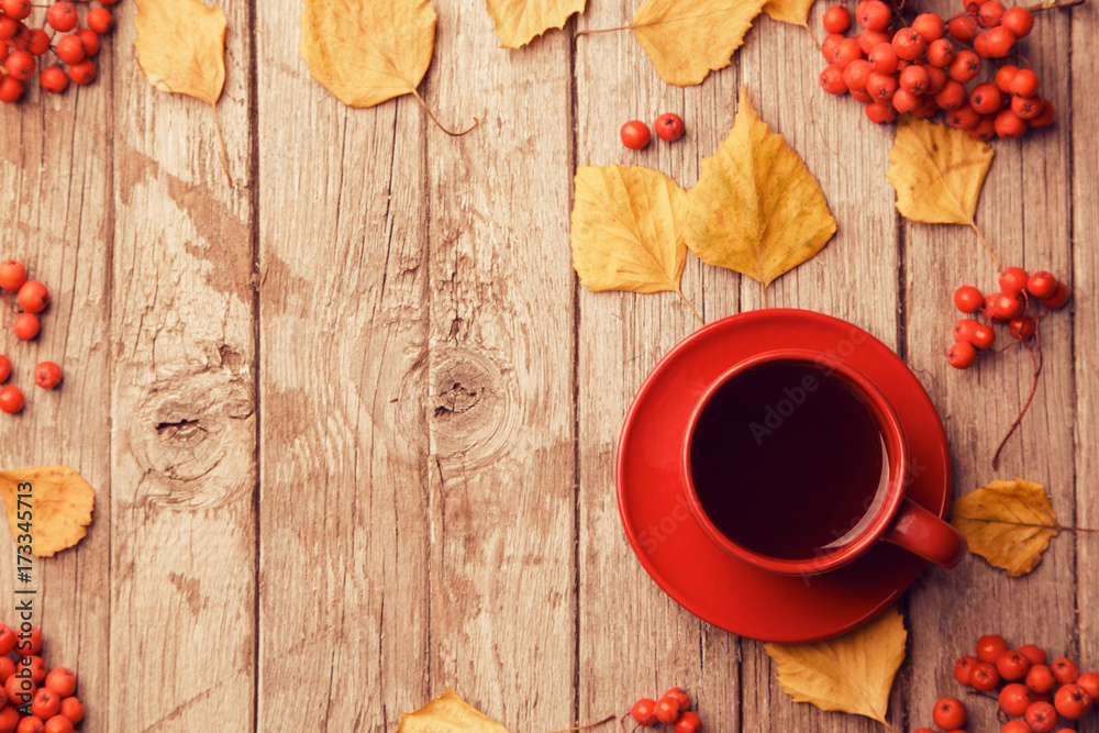 Red cup of coffee on grey wooden background, top view, copy space