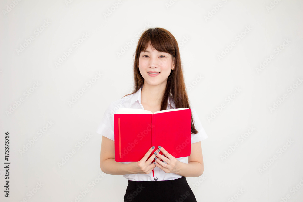 Portrait of thai adult student university uniform beautiful girl read red book Portrait of thai adult student university uniform beautiful girl read red book