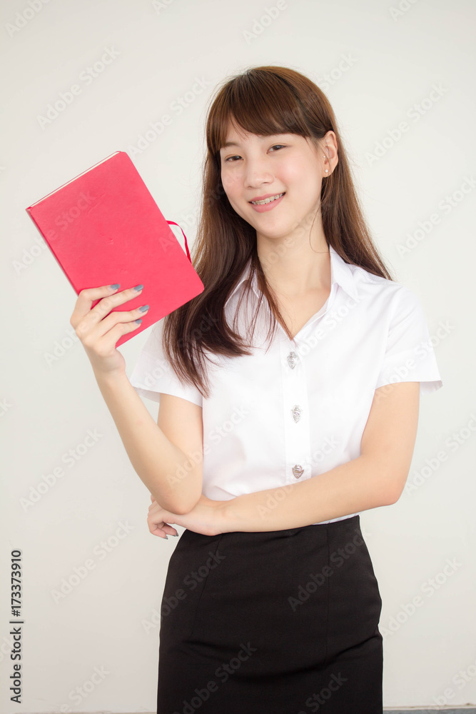 Portrait of thai adult student university uniform beautiful girl read red book Portrait of thai adult student university uniform beautiful girl read red book