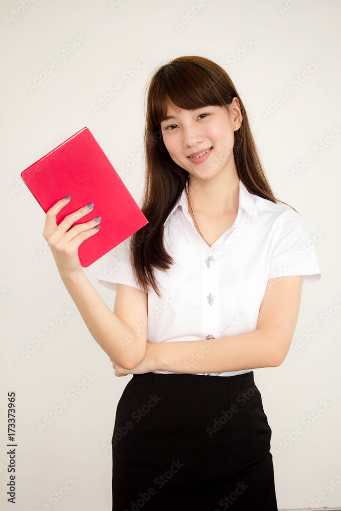 Portrait of thai adult student university uniform beautiful girl read red book Portrait of thai adult student university uniform beautiful girl read red book