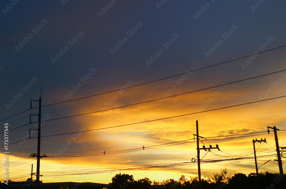 high-voltage power lines at sunset.