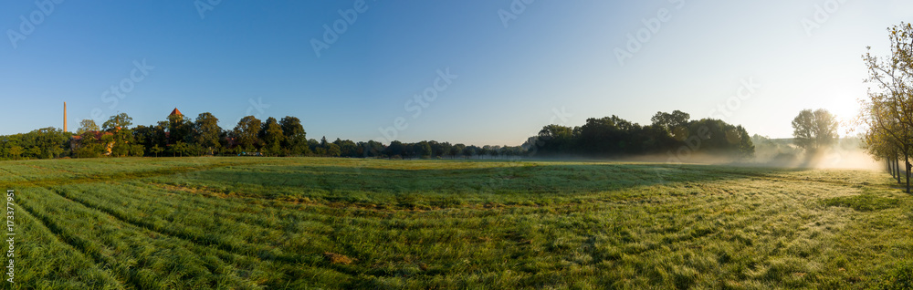 Panoramic view of the morning field. Fog above the ground. Wuhlgarten, Berlin district of Marzahn-Hellersdorf.