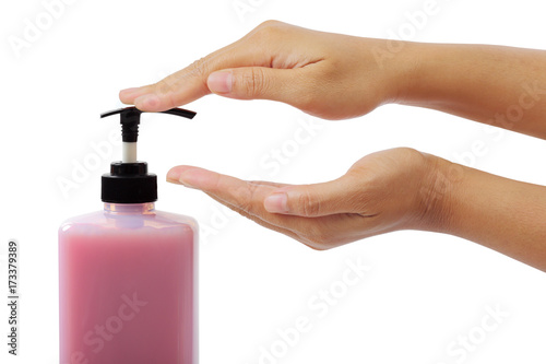 Woman hands pushing pump plastic bottle isolated on white with clipping path.