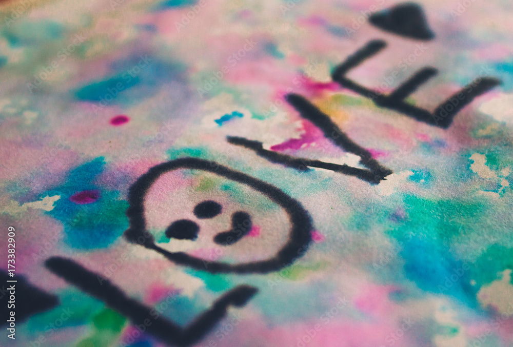 The word love painted with water colors