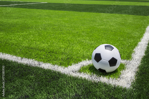 Soccer ball on artificial bright and dark green grass at public outdoor football or futsal stadium © SKT Studio