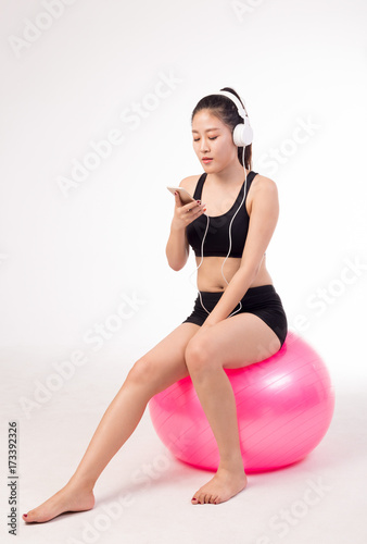 asian girl playing yoga ball