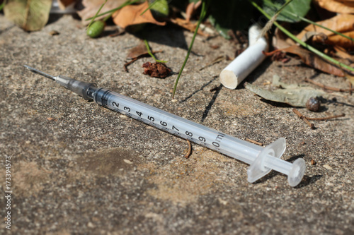 used and discarded syringe on the street