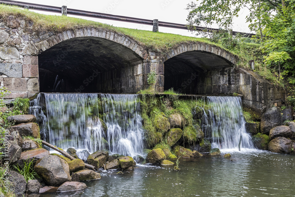 very steep waterfall flowing beneath the bridge very steep waterfall flowing beneath the bridge