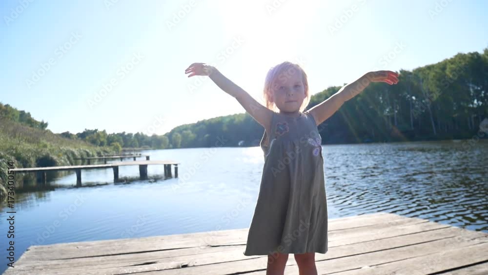 The girl on the pier rejoices in the sun. The girl on the pier rejoices in the sun.