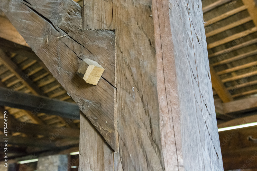 Securing two beams in the interior of the barn.