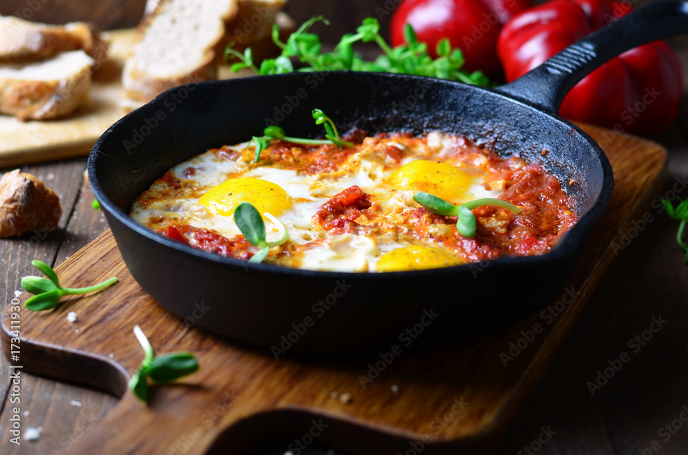 Shakshuka, Fried Eggs with Tomato Sauce in a Pan, Rustic Style and Wooden Background Shakshuka, Fried Eggs with Tomato Sauce in a Pan, Rustic Style and Wooden Background