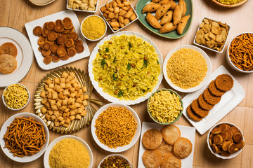 stock photo of  Diwali food or Diwali snacks or Diwali sweets like anarsa, bakarvadi, chakli, sev, bhujiya, shankar pale and chivda or chiwada, karanji, favourite indian diwali recipe, 