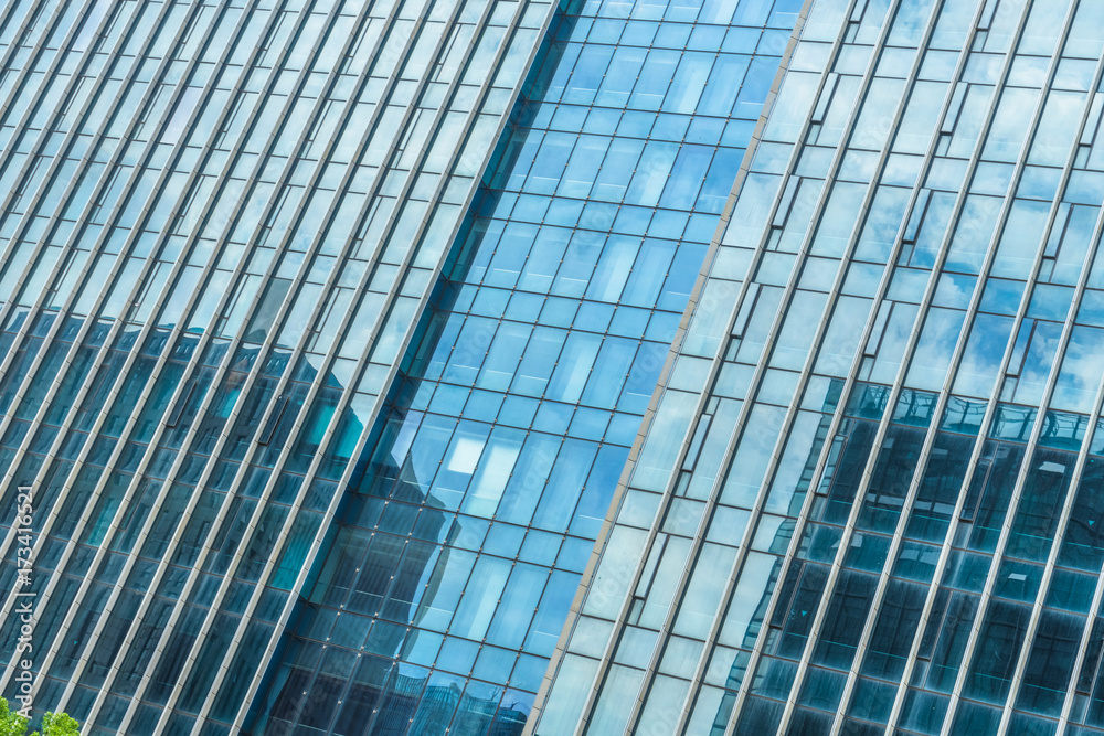 Clouds reflected in windows of modern office building.