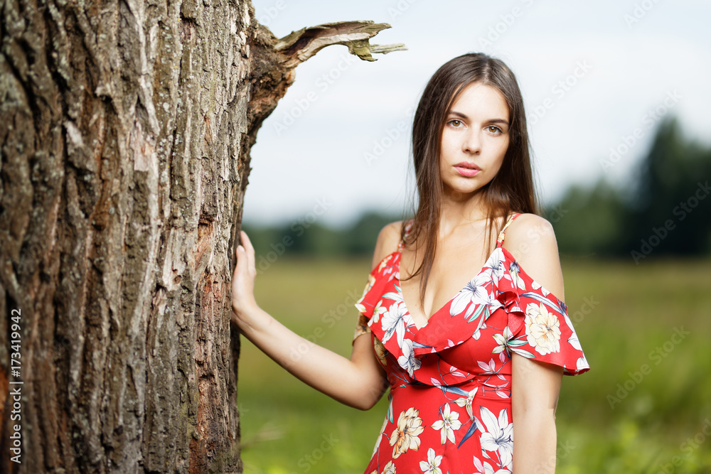 Outdoors portrait of beautiful brunette girl looking at camera Outdoors portrait of beautiful brunette girl looking at camera