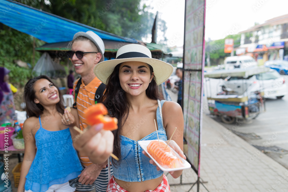 Group Of Tourists Eat Fresh Tropical Fruits Walking Of Asian City Cheerful Young People On Vacation Together Holiday And Communication Concept Group Of Tourists Eat Fresh Tropical Fruits Walking Of Asian City Cheerful Young People On Vacation Together Holiday And Communication Concept