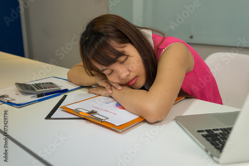 Hardworking office employee sleeping in office photo