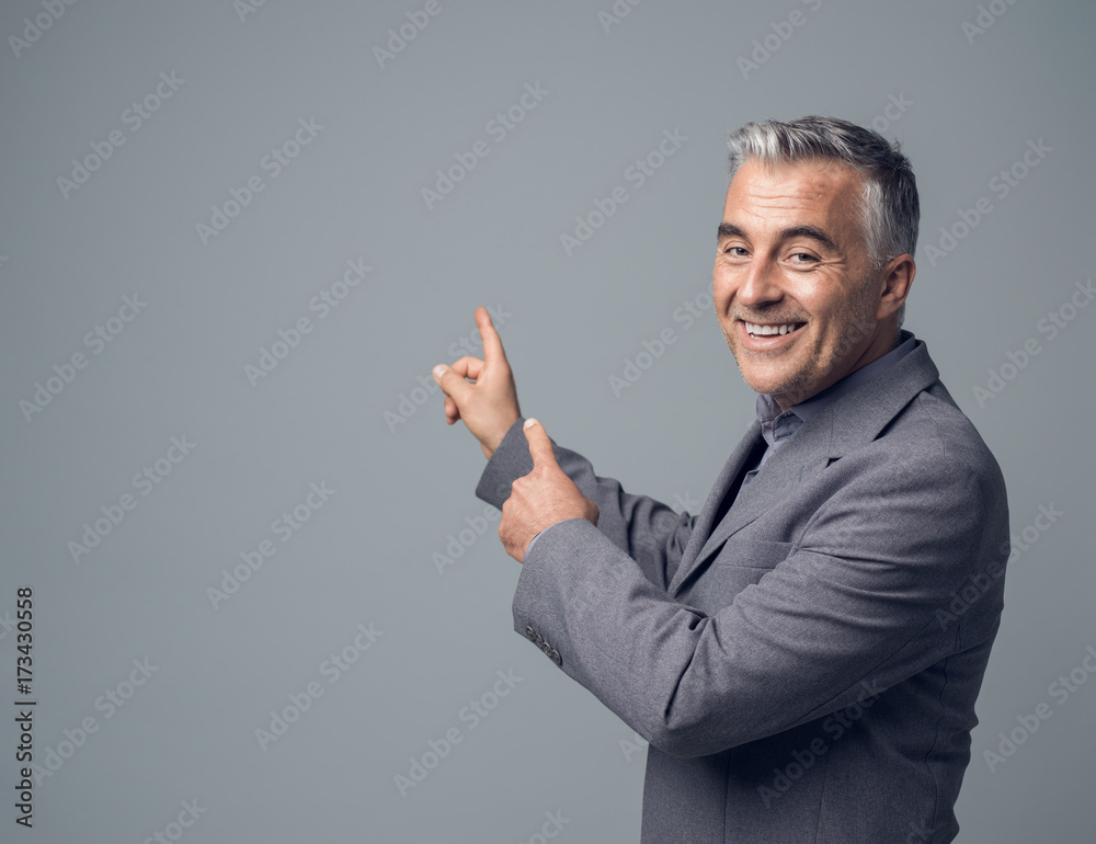 Businessman pointing at blank copyspace Businessman pointing at blank copyspace