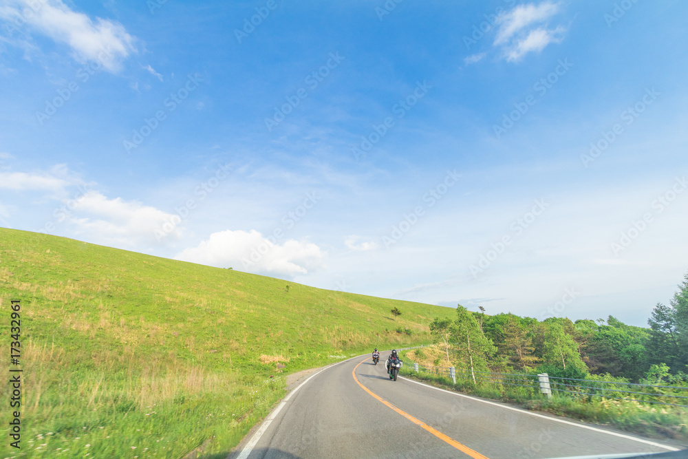 Beautiful  landscape view of  a country road and green grass with  blue sky  background of Utsukushigahara park is  one of the most important and popular natural place in Nagano Prefecture , Japan.