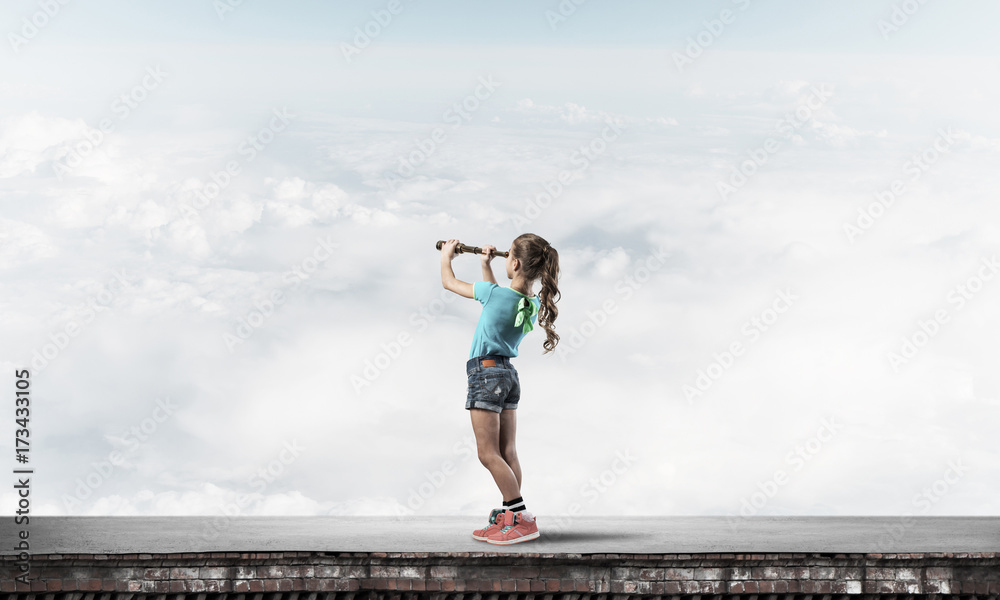 Concept of careless happy childhood with girl exploring this wor Concept of careless happy childhood with girl exploring this wor