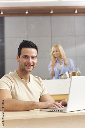 Young man using laptop computer at home